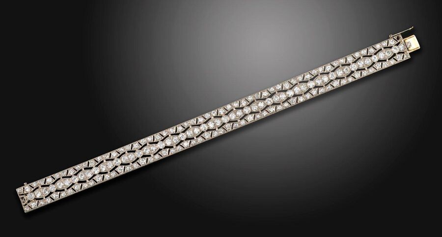 A diamond bracelet, the pierced geometric design is millegrain-set with...
