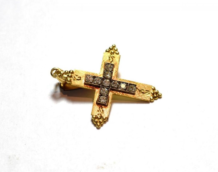 A diamond cross pendant, the cross motif set throughout with...