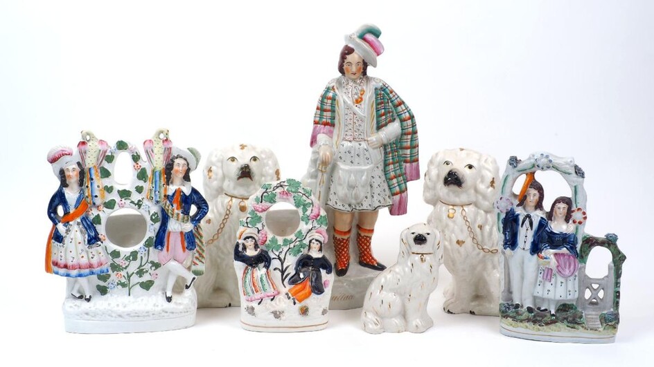 A group of seven Victorian Staffordshire figures, to include a large figure of William Wallace, 39cm high, two large spaniels, 22cm high, with a smaller spaniel, 14cm high, and three flat-back figure groups (7)