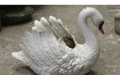 A heavy antique cast iron planter in the form of a swan with...