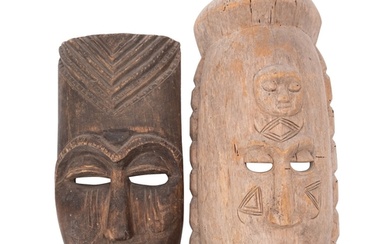 A large African carved wood mask, with a sleeping face carve...