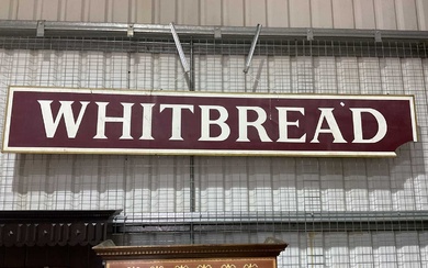 A large advertising sign. 'Whitbread', on plyboard backing (loss to...
