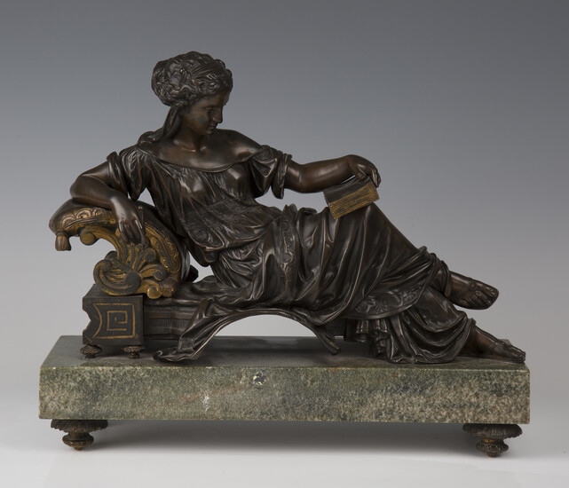 A late 19th century French brown and gilt patinated cast bronze figure of a Classical lady relaxing