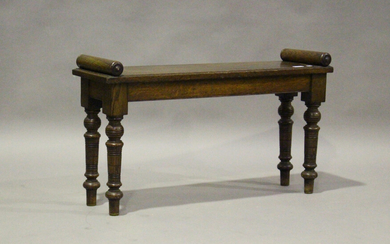 A late Victorian oak window seat with turned handrests, on ring turned legs, height 52cm, width 90cm