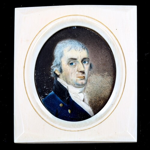 A miniature painted portrait on ivory of a gentleman wearing...