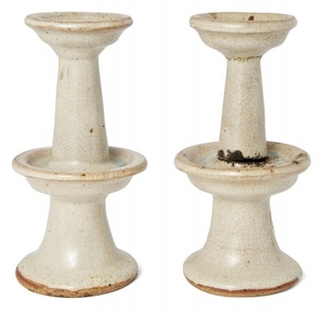 A pair of Chinese stoneware candlesticks, late...