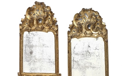 A pair of Danish Rococo giltwood mirrors each richly carved with openwork carvings and facet-cut glass. C. 1760. H. 78 cm. W. 41 cm. (2)