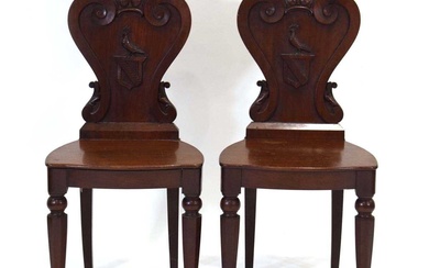 A pair of Victorian mahogany armorial hall chairsCondition Report There...