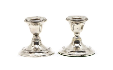 A pair of dwarf silver candlesticks