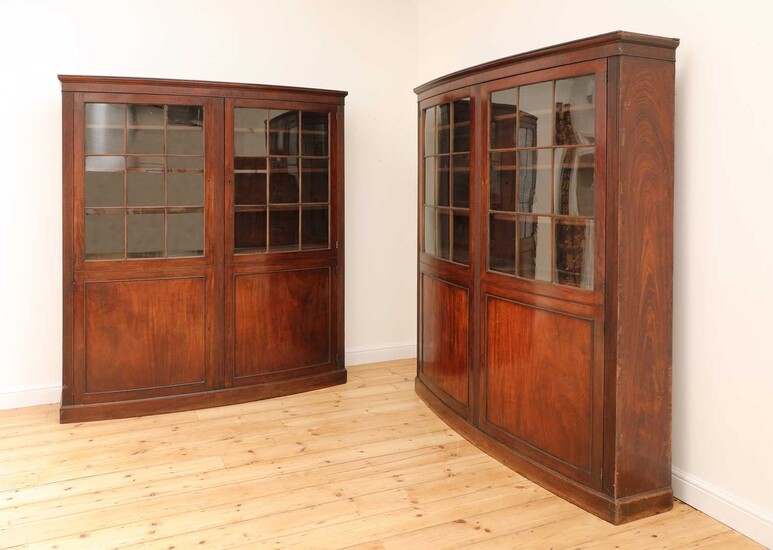 A pair of mahogany bow front bookcases