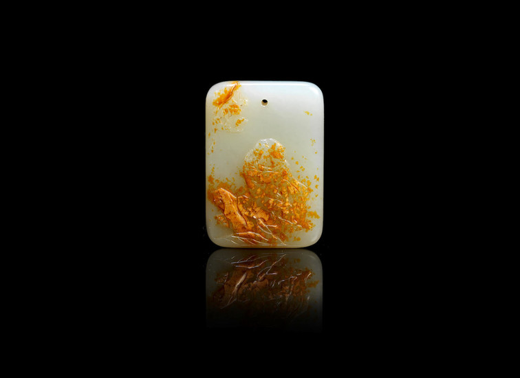 A pale green and russet jade plaque