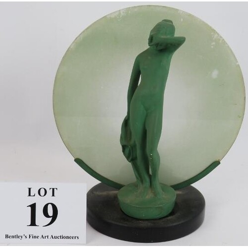 A period Art Deco lamp with nude figure backlit by a moon sh...