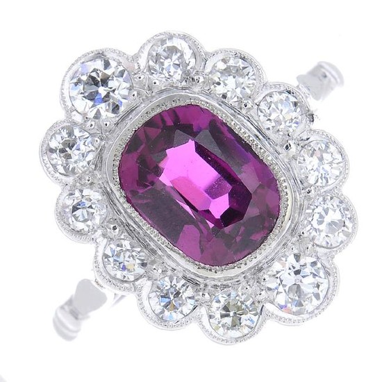 A platinum ruby and diamond cluster ring. The