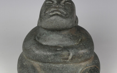 A pre-Columbian Olmec style carved green hardstone figure, probably 900-450 BC, modelled as a seated