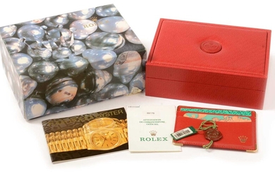 A red leather Rolex box, papers and tags