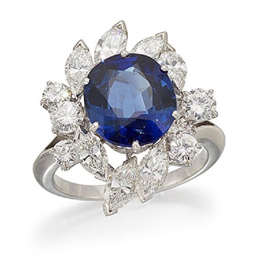 A sapphire and diamond cluster ring, the central...