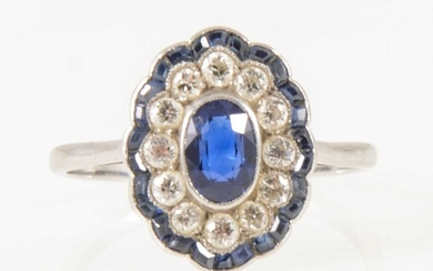 A sapphire and diamond oval cluster ring in the Art Deco style.