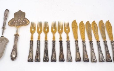 A set of German fish eaters for six, the handles stamped 800 for silver, designed with Art Nouveau style decoration to handles and gilt metal blades and prongs, together with two serving slices, both handles stamped 800 (14)