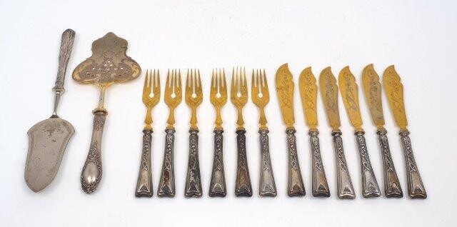 A set of German fish eaters for six, the handles stamped 800 for silver, designed with Art Nouveau style decoration to handles and gilt metal blades and prongs, together with two serving slices, both handles stamped 800 (14)