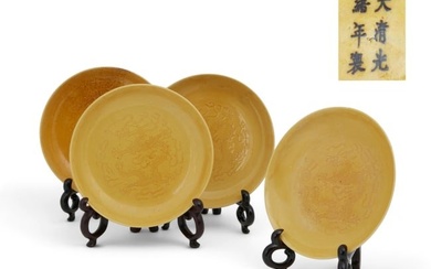 A set of four Chinese yellow glazed dragon dishes