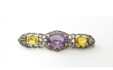 A silver brooch set with amethyst, citrine and marcasite. Ap...