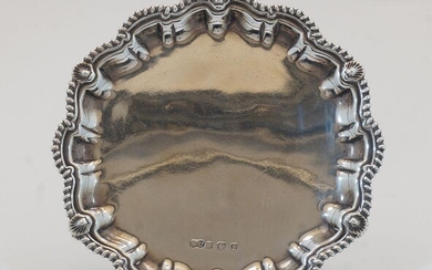 A silver card tray, Birmingham, 1929, William Suckling Ltd, with scalloped, gadrooned and shell rim on three scroll feet, 16cm dia., weight approx. 6.3oz