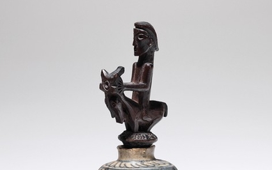 A small magic 'Pupuk' container with equestrian figure.
