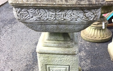 A square composition stone urn cast with frieze of roses...