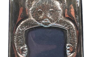 A vintage silver mounted child's photograph frame, the embossed mount depicting a teddy bear