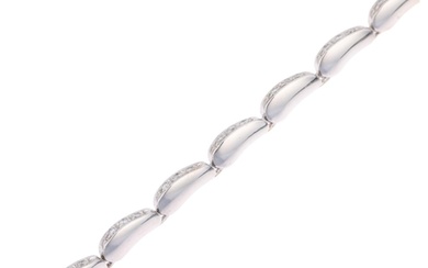An 18ct white gold diamond tennis line bracelet, pave set wi...