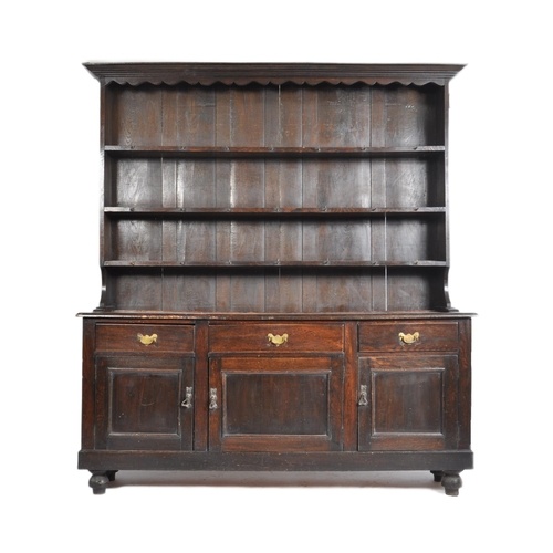An 18th century George III oak Welsh dresser. Raised on brac...