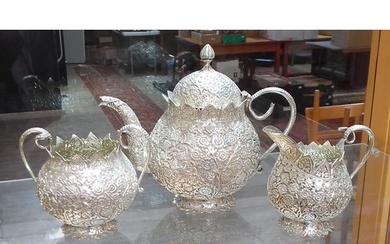 An Egyptian three piece silver tea set, profusely decorated ...