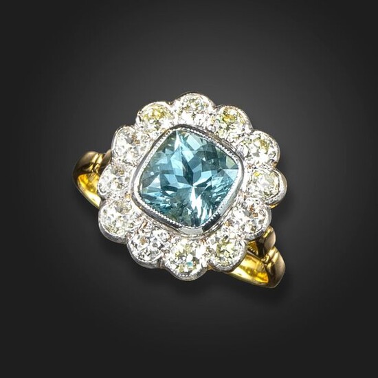 An aquamarine and diamond cluster ring, the square cushion-shaped aquamarine...