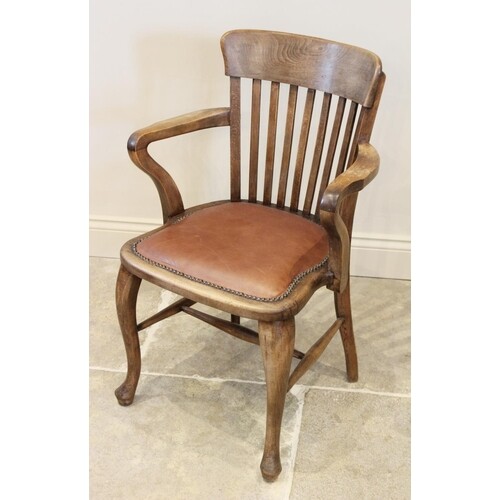 An early 20th century stained beech wood desk chair, the lat...