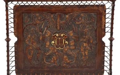 An embossed leather and walnut fire screen