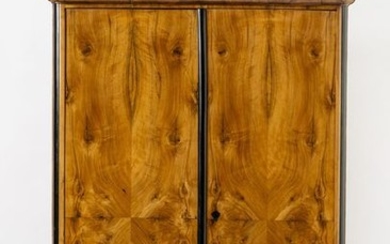 Biedermeier cupboard. Walnut veneer. Two-door carcass with rounded,...