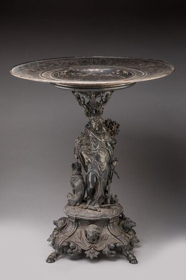 COMPETITION TROPHY by FROMENT-MEURICE, 1858 in chased and repoussé silver. Circular cup engraved with foliage and agrarian symbols, inscribed on the rim "REGIONAL COMPETITION OF ALENCON PRIME D'HONNEUR 1858". A baluster shaft to which two female...