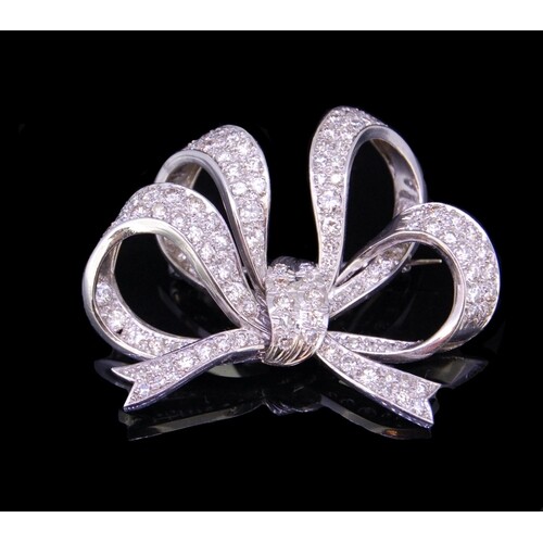 DIAMOND BOW BROOCH, of openwork knotted design, set with dia...