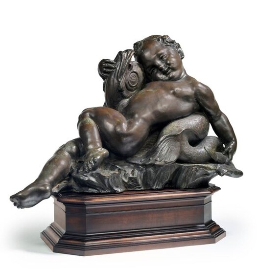 Group forming a bronze fountain with a brown patina representing a putto playing with a dolphin. On a moulded and patinated wooden base.