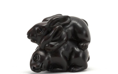 JAPANESE WOOD NETSUKE In the form of two rabbits. Signed. Length 1.75".