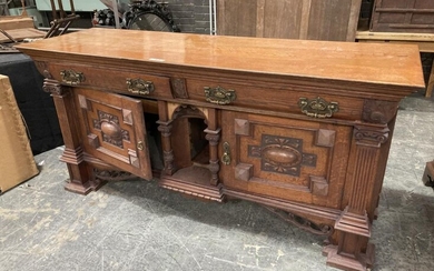 Late Victorian Oak Sideboard, with two frieze drawers, central columned niche, flanked by two cruciform panel doors, further flanked...