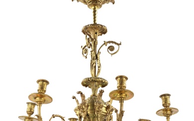 Le lustre en bronze doré de style Louis XVI maintient un équilibre élégant entre boucles...
