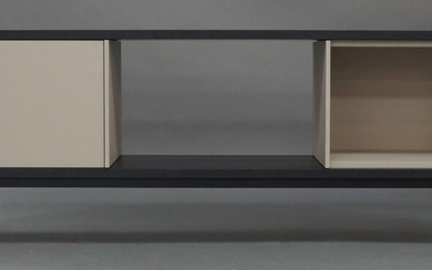 Marc Krusin (b.1973) for Punt, a 'Slats 1800' low sideboard / tv stand, of recent manufacture, the ebonised top above open compartments and one sprung cupboard door, on black powder coated square section steel supports, 62cm high, 180cm wide, 40cm...