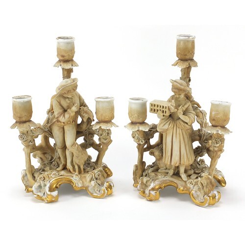 Pair of continental porcelain figural three branch candelabr...