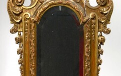 Regency style mirror-console in carved and gilded wood with vegetal decoration and topped by a "Mascaron". Period: 19th century. (*). H.:+/-114cm.