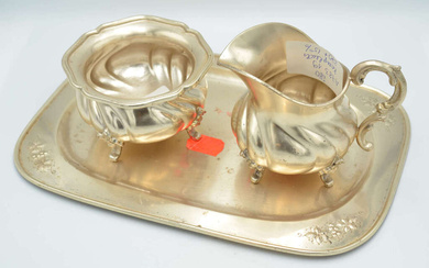 Set of silver objects - tray, sugar bowl, cream bowl First half of 20th century. Silver, proof 925. Tray - 283.64 g, 24.5x17 cm, cream bowl - 127.06 g, 8.5x11.5 cm, sugar bowl - 145.19 g, 6x9 cm