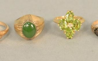 Six gold rings, five with stones, peridots, red stones