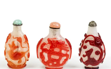 Three Chinese ruby-red overlay snowstorm glass snuff bottles Late Qing dynasty Comprising:...