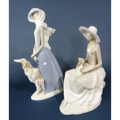 Two Lladro figure groups, one of an elegant lady with a borz...
