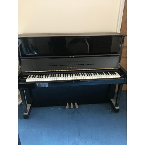 Yamaha (c1976) A Model U1 upright piano in a bright ebonised...